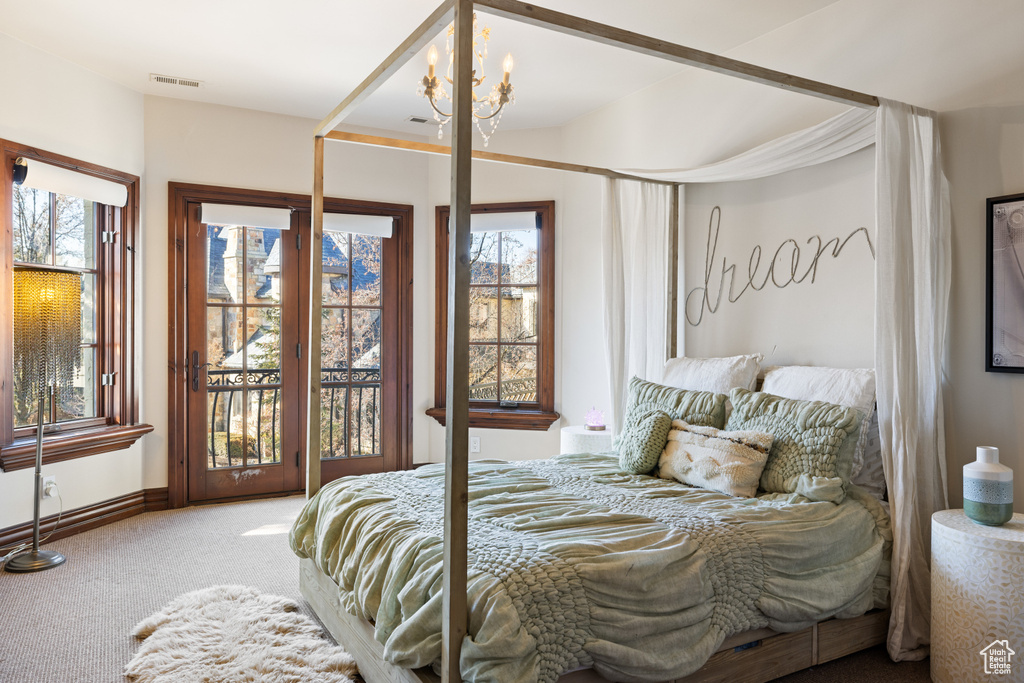 Carpeted bedroom featuring access to outside and baseboards