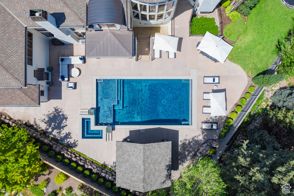 Aerial view of property and surrounding area with a pool area