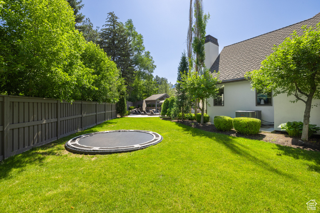 View of yard featuring a trampoline