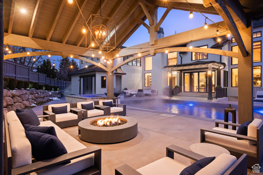 View of patio / terrace with an outdoor living space with a fire pit, an outdoor pool, and an outdoor hot tub