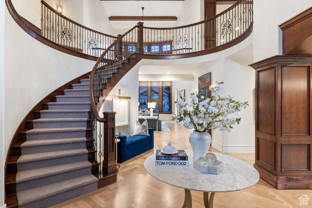 Entryway with stairway and a high ceiling