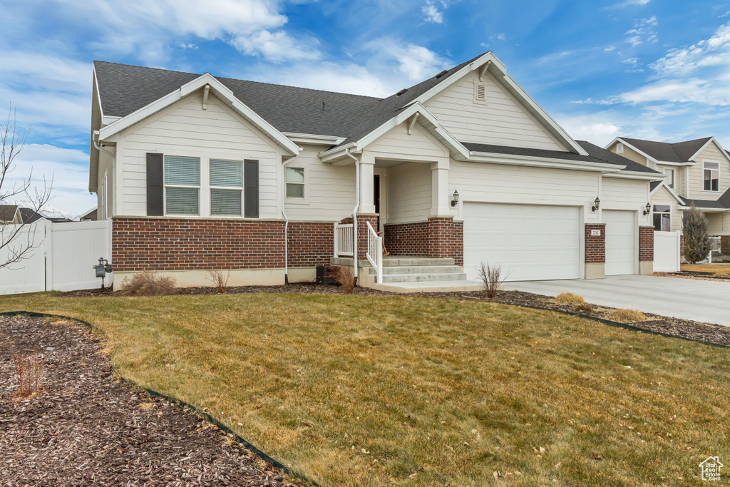 View of front of home with a garage and a front yard