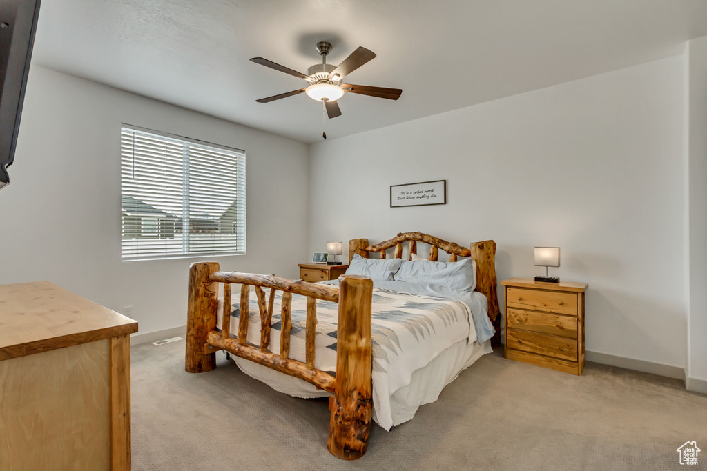 Carpeted bedroom featuring ceiling fan