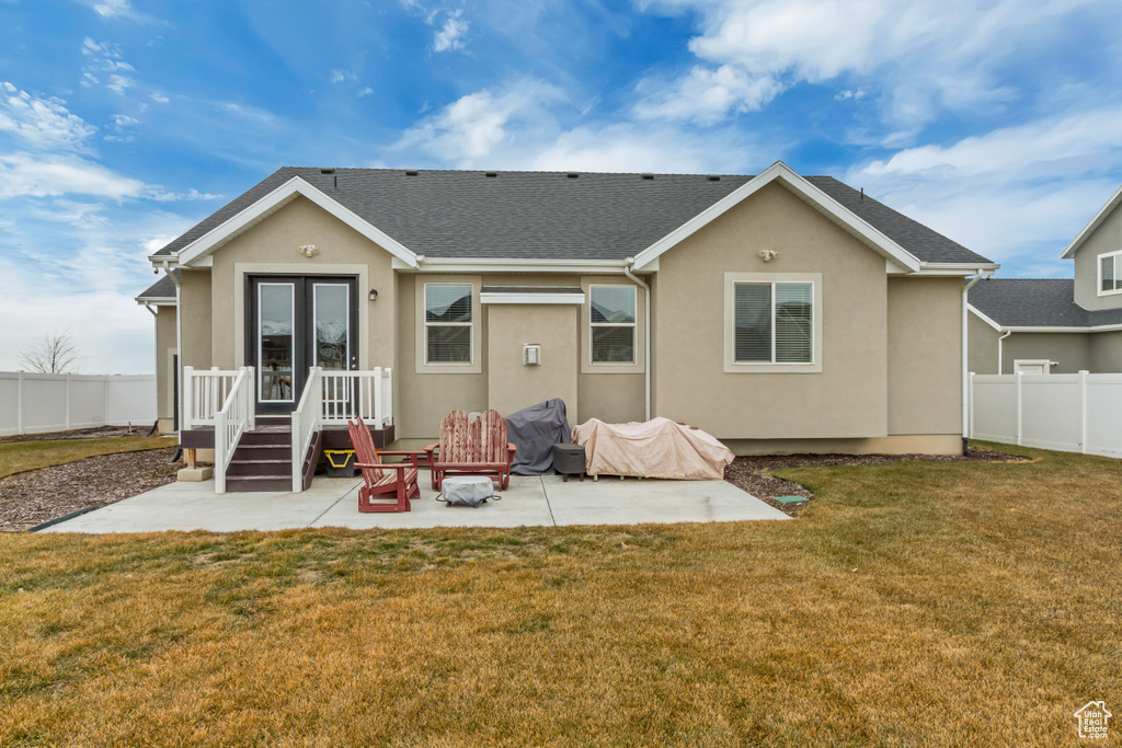 Back of house featuring french doors, a yard, and a patio