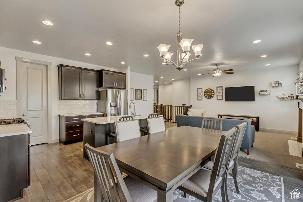 Dining area with ceiling fan, sink, and light wood-type flooring