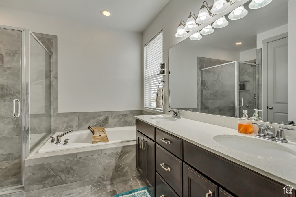 Bathroom featuring independent shower and bath and vanity