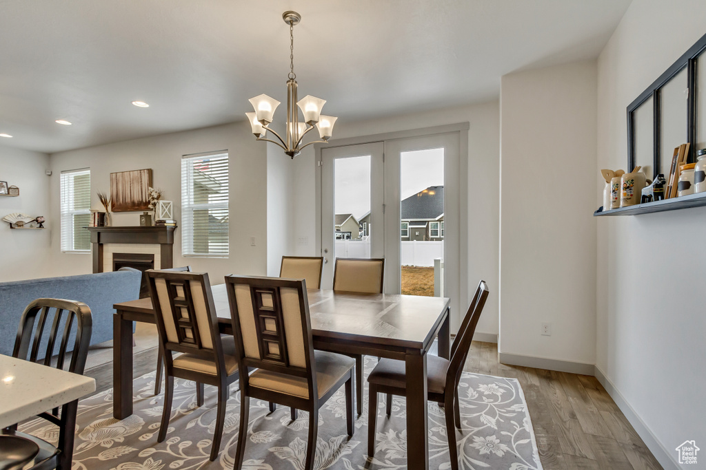 Dining room featuring light hardwood / wood-style flooring and a notable chandelier
