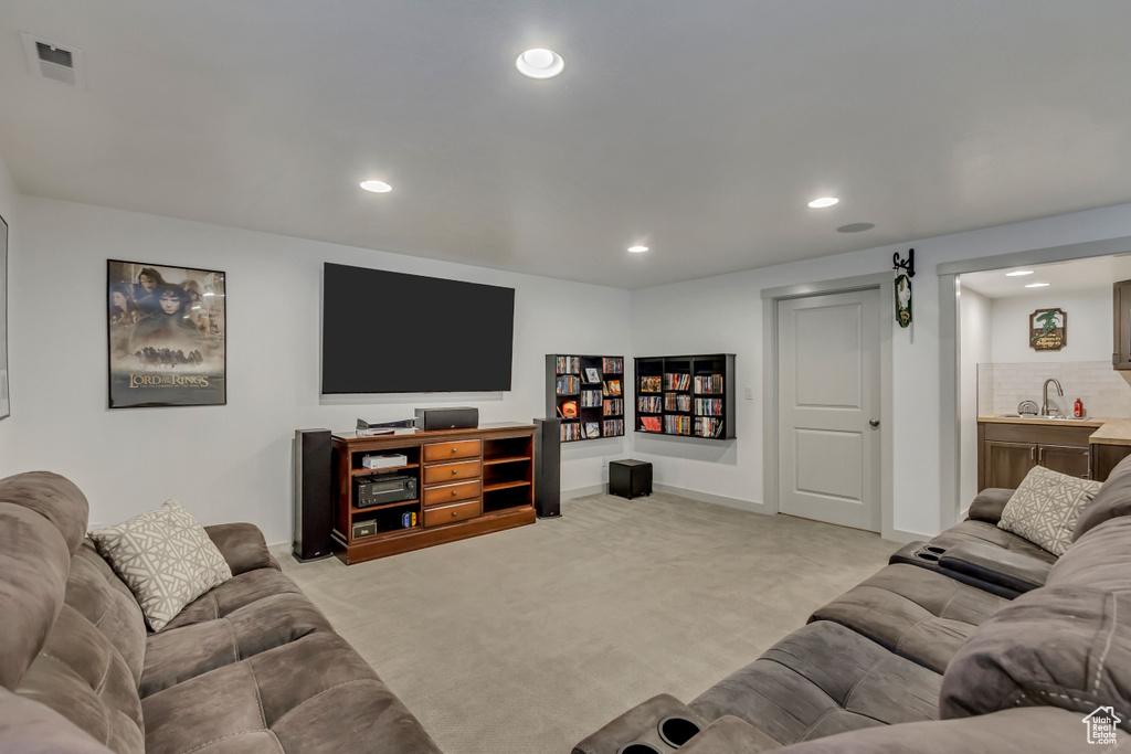 Living room featuring light carpet and sink