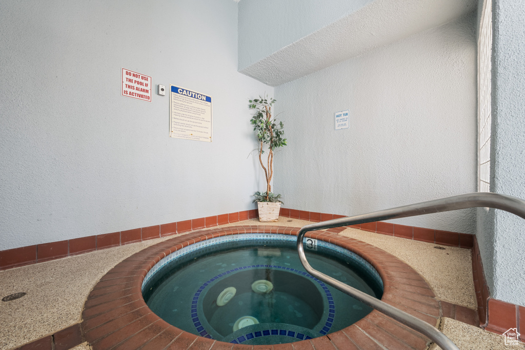 View of pool with an indoor in ground hot tub