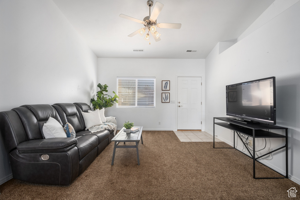 Carpeted living room with ceiling fan
