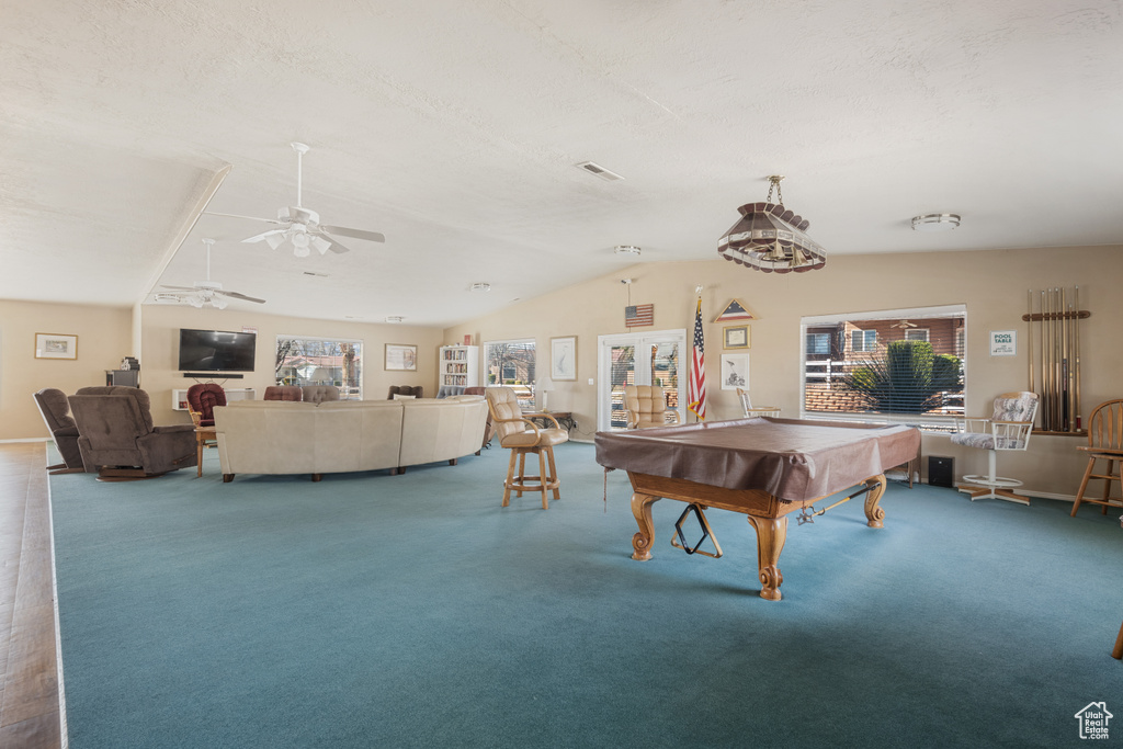Game room featuring lofted ceiling, ceiling fan, carpet flooring, a textured ceiling, and pool table