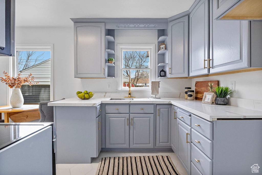 Kitchen with gray cabinets and sink