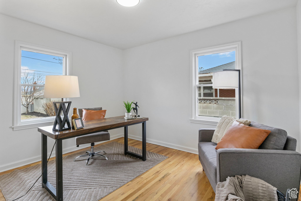 Office area with hardwood / wood-style flooring and a healthy amount of sunlight