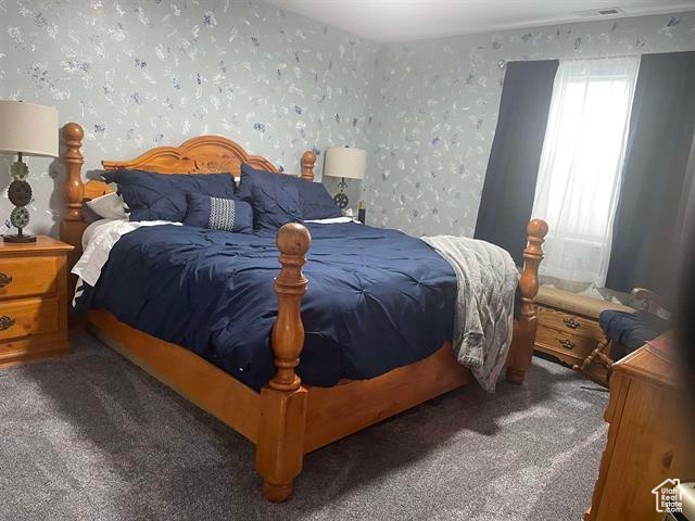 Bedroom with dark carpet