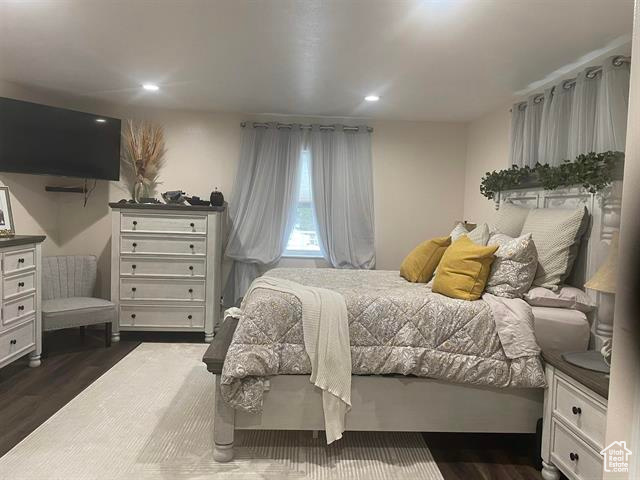 Bedroom with dark wood-type flooring