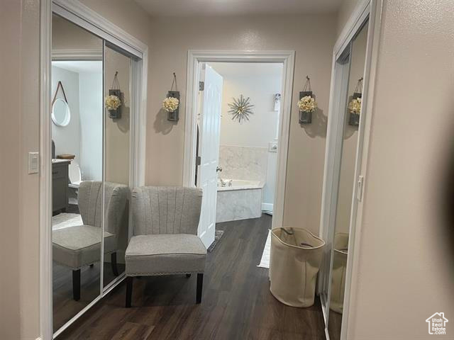 Hallway with dark hardwood / wood-style floors