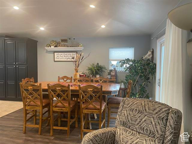 Dining space with dark hardwood / wood-style flooring