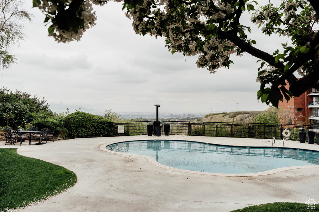 Community pool with fence and a patio