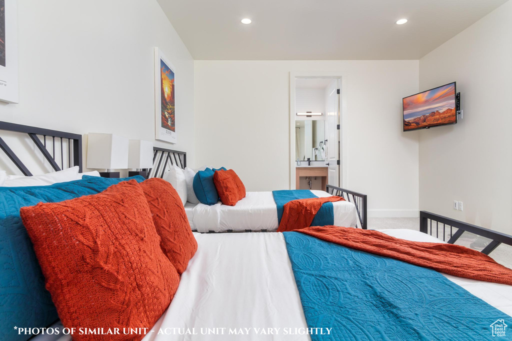 Bedroom featuring ensuite bath and carpet floors