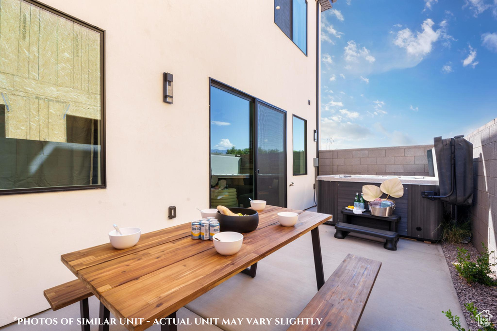 View of patio / terrace with a hot tub