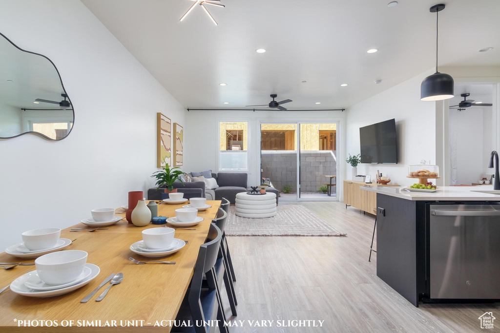 Dining space featuring ceiling fan, sink, and light hardwood / wood-style floors