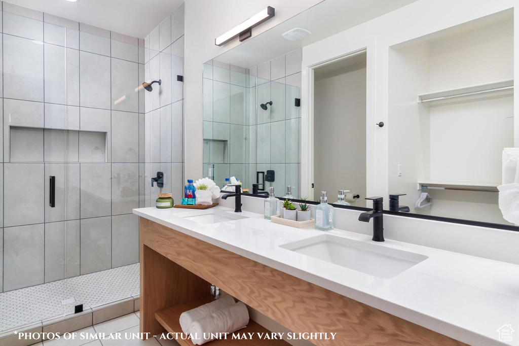 Bathroom featuring vanity and a shower with door