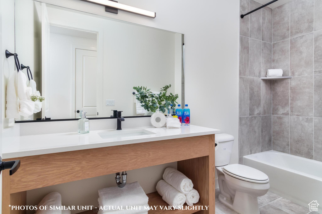 Full bathroom with tile patterned flooring, tiled shower / bath, sink, and toilet