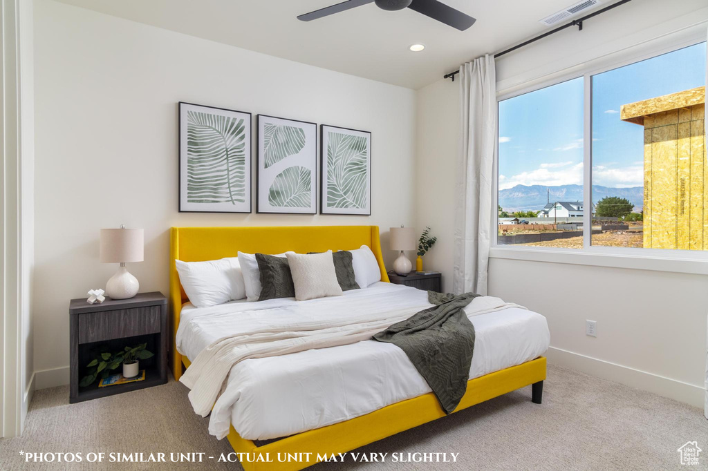 Carpeted bedroom with ceiling fan and a mountain view