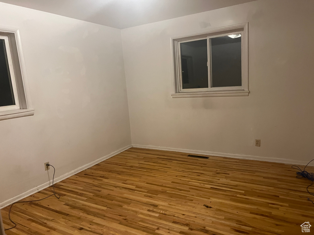 Empty room featuring hardwood / wood-style floors