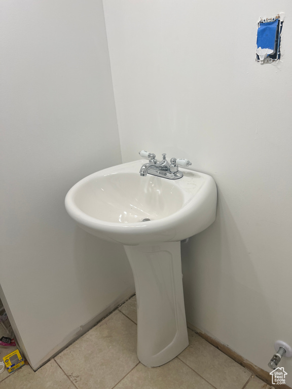 Bathroom featuring tile patterned floors and sink