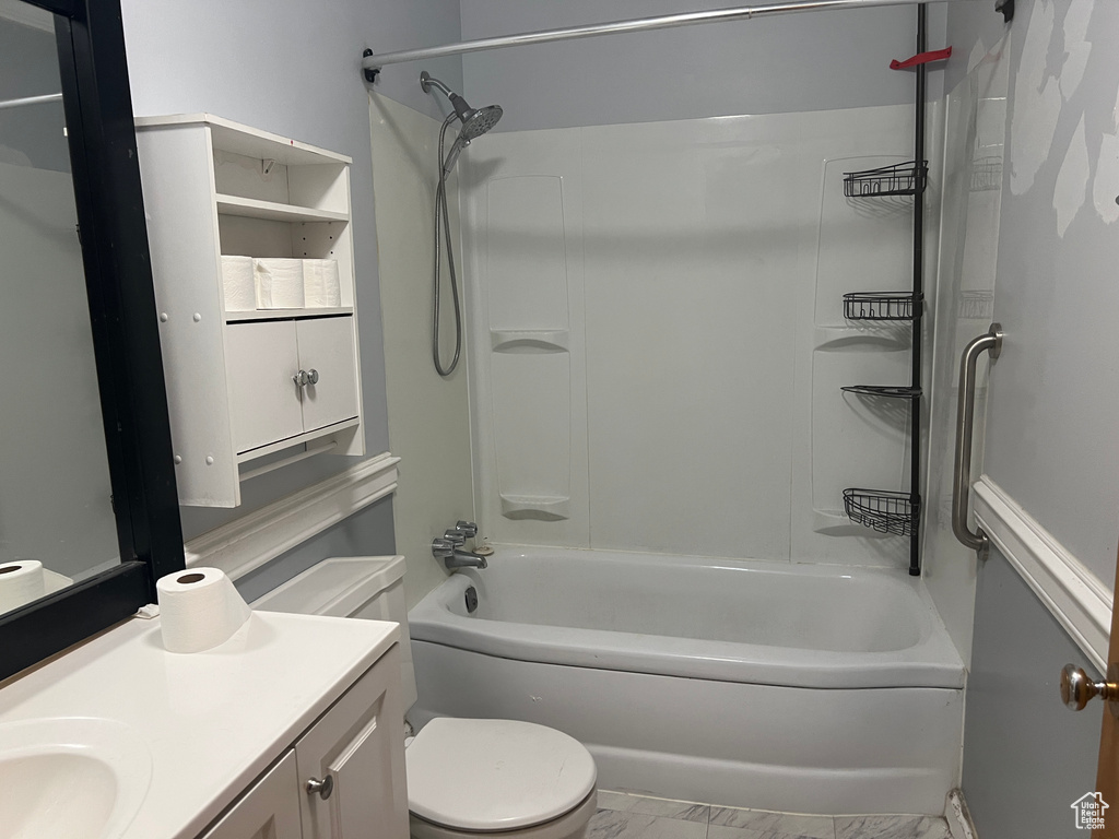 Full bathroom featuring washtub / shower combination, vanity, and toilet