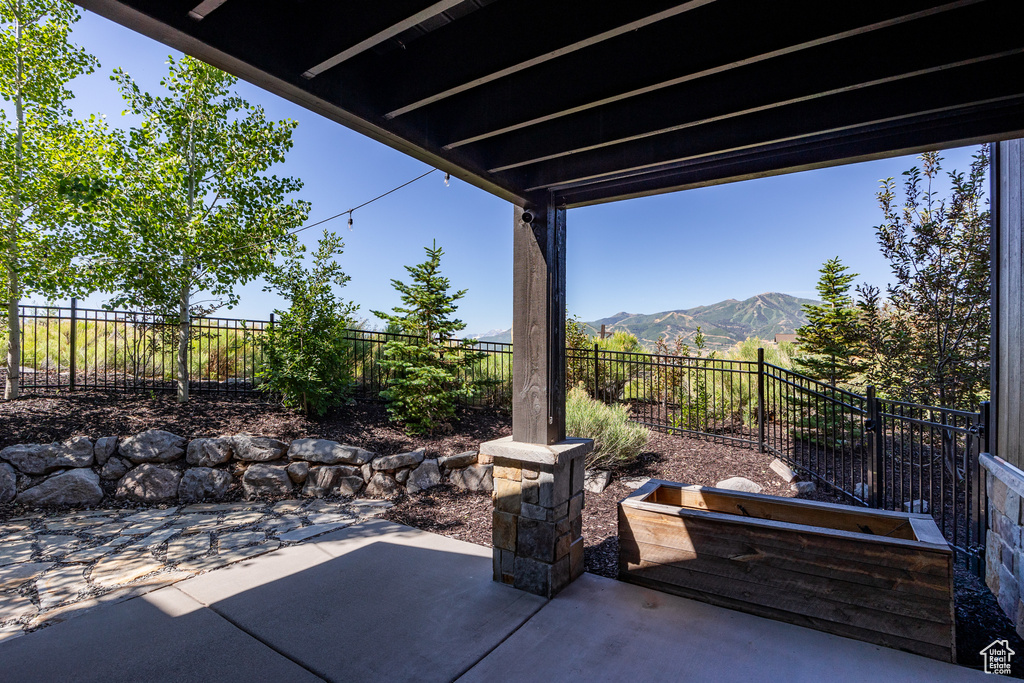 Fenced backyard featuring a patio and a mountain view