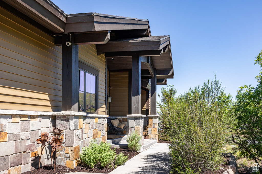 Doorway to property featuring stone siding