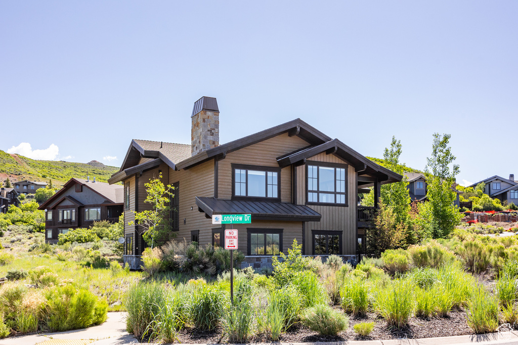 Rear view of house featuring a chimney and a mountain view