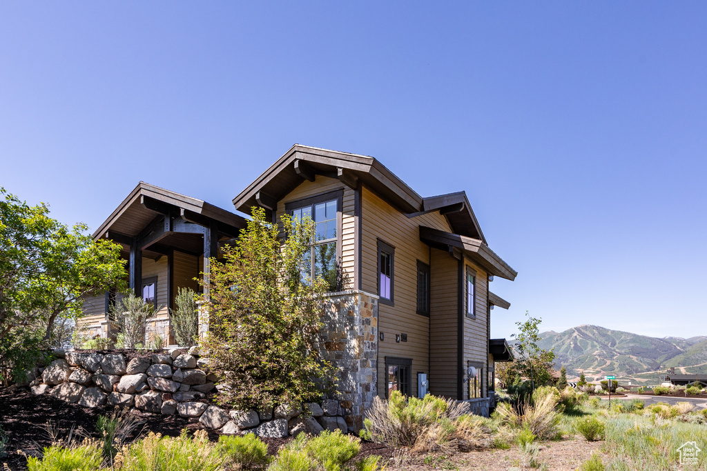 View of side of property with a mountain view