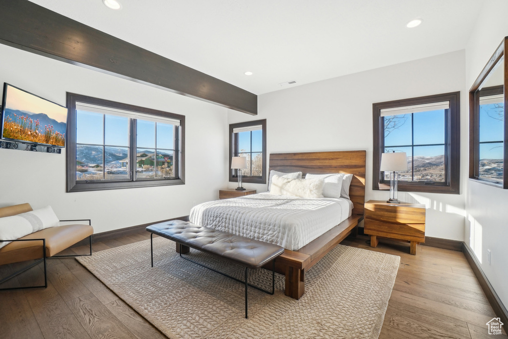 Bedroom featuring hardwood / wood-style flooring, baseboards, and recessed lighting