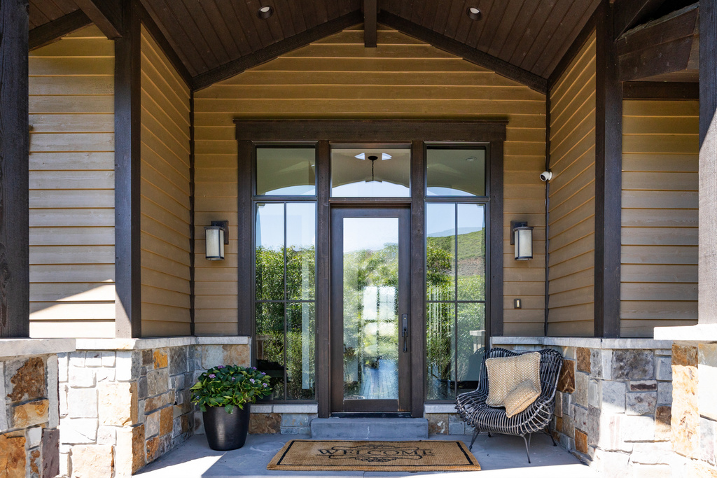 Property entrance featuring stone siding