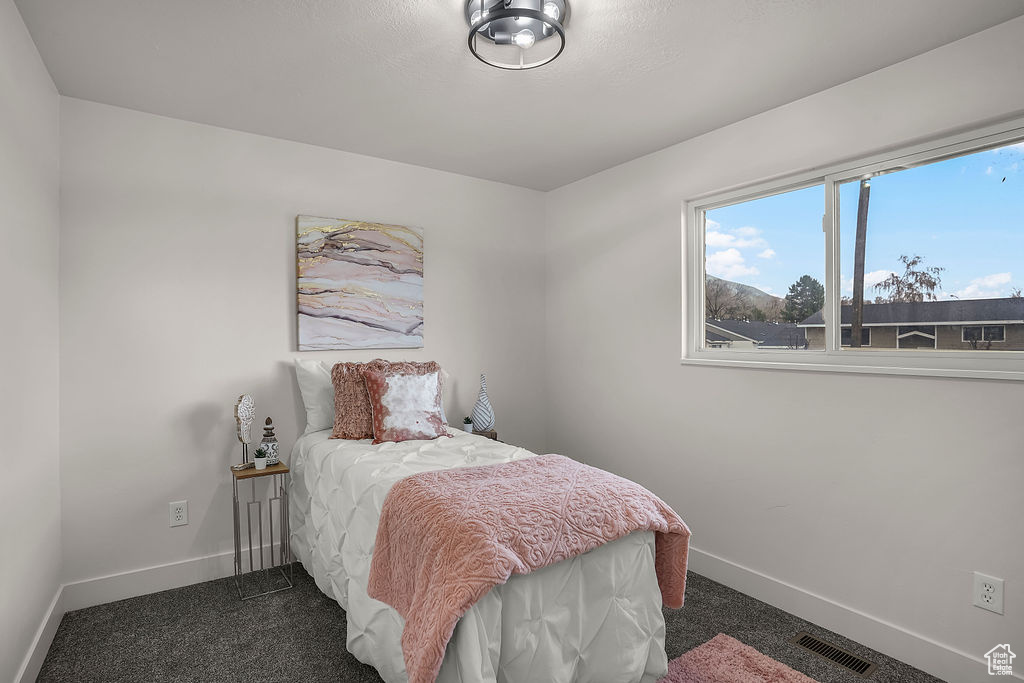 Bedroom featuring dark colored carpet