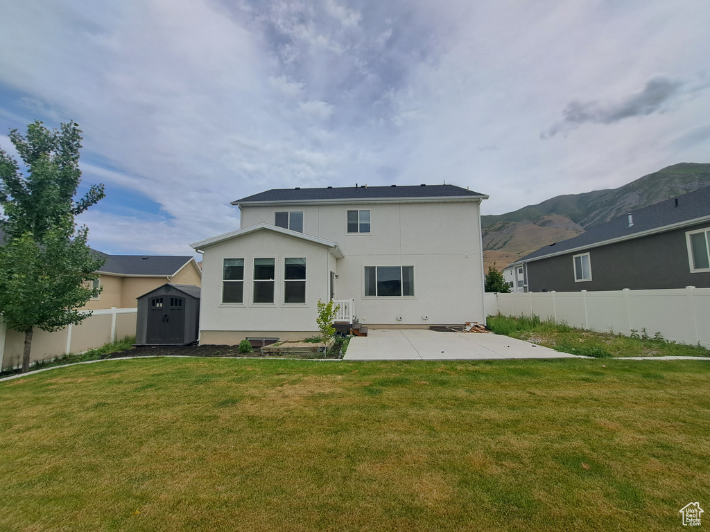 Back of house featuring a patio area, stucco siding, and a mountain view
