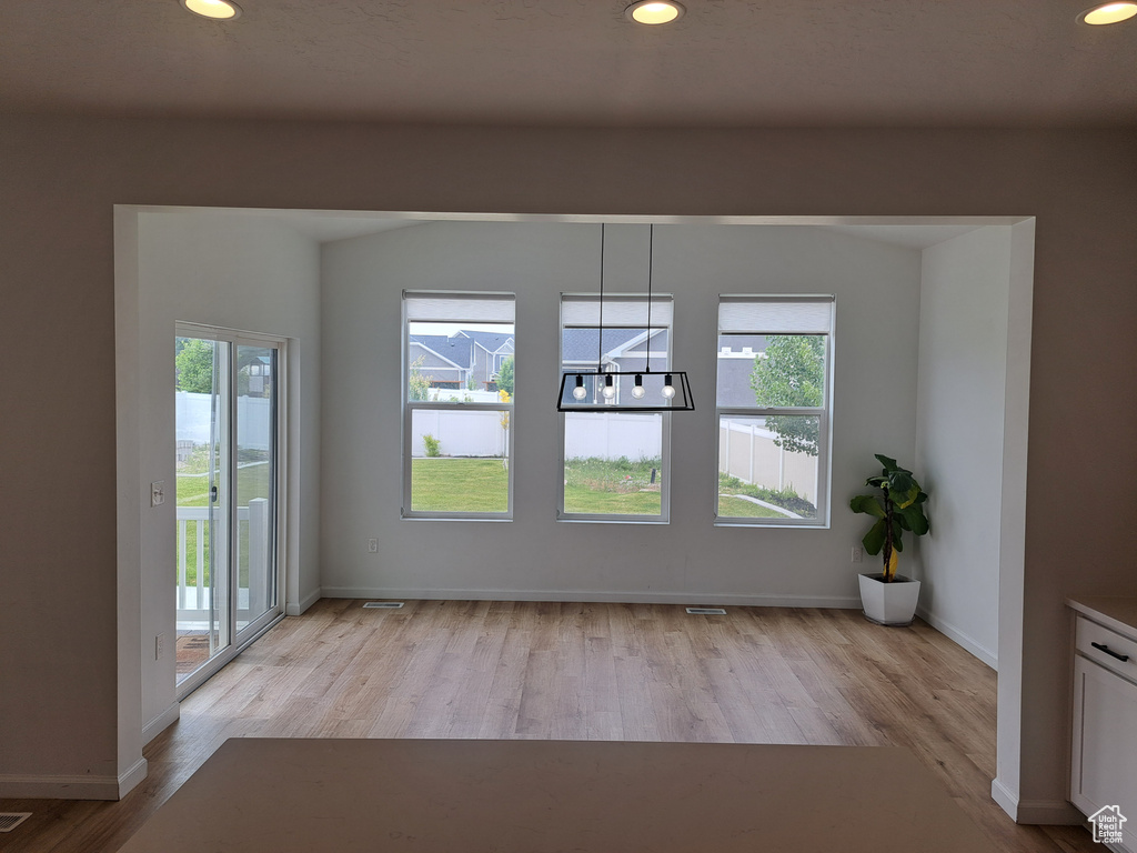 Unfurnished room featuring light wood finished floors, recessed lighting, and baseboards