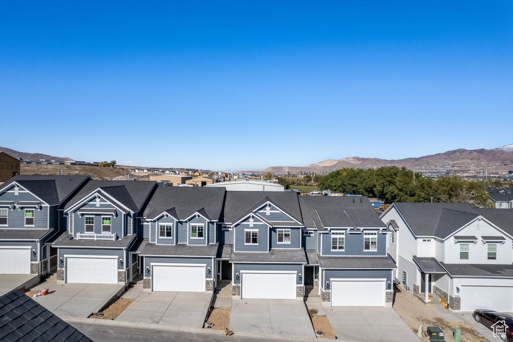 Townhome / multi-family property with a mountain view