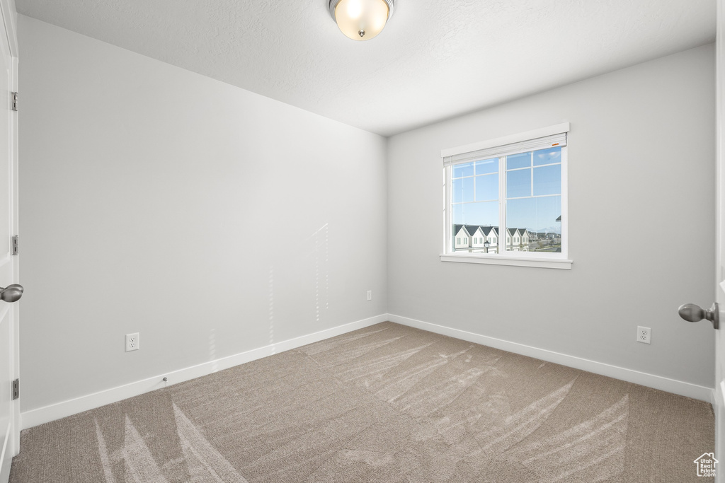 Empty room featuring carpet flooring