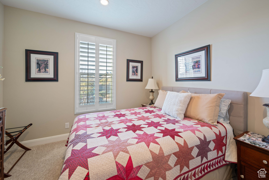 Bedroom with light colored carpet