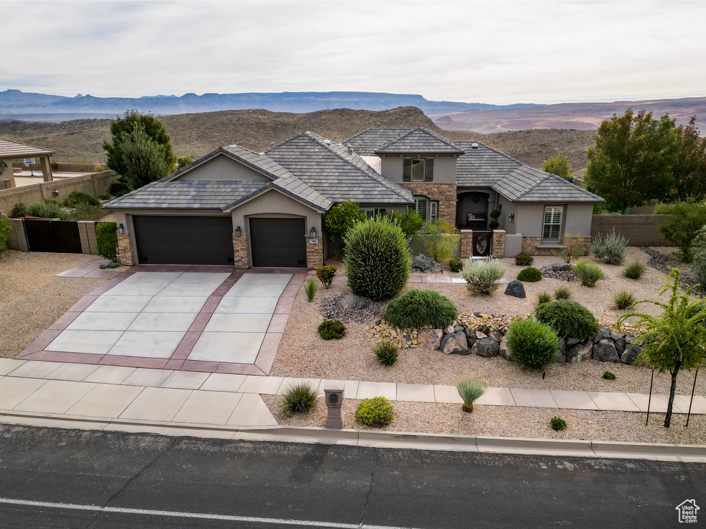 View of front facade featuring a garage and a mountain view