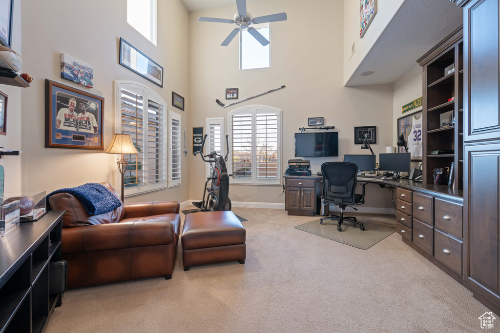 Carpeted home office with ceiling fan
