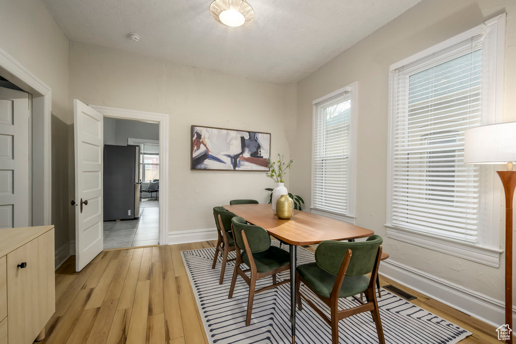 Dining area with light wood-type flooring