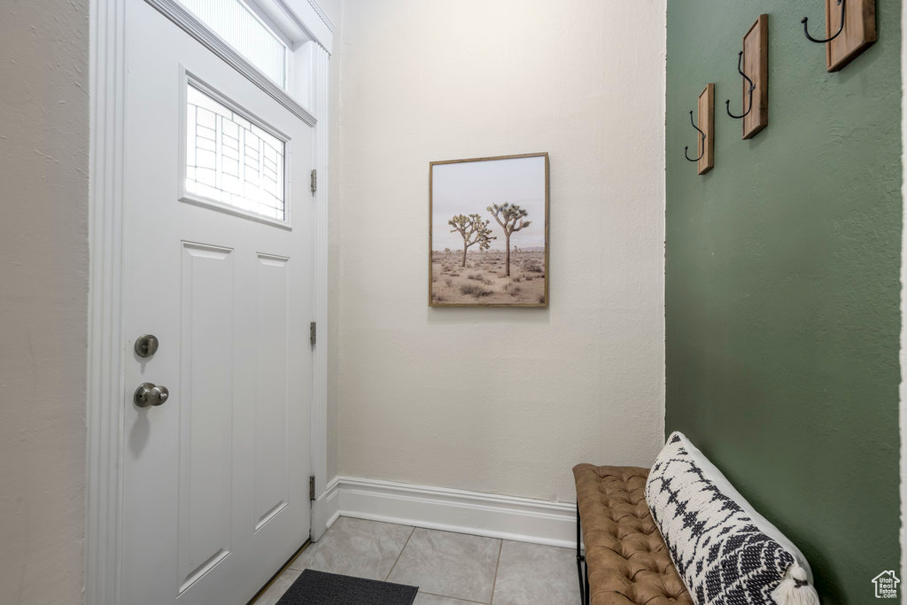 Doorway featuring light tile patterned flooring