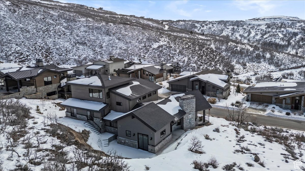 Snowy aerial view featuring a mountain view