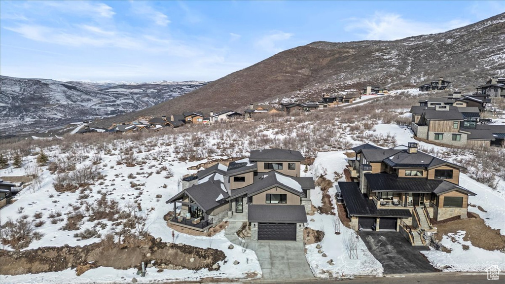 Snowy aerial view featuring a mountain view