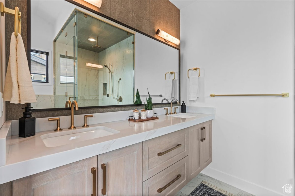 Bathroom featuring an enclosed shower and vanity